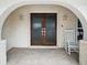 Charming entryway features a tiled porch, decorative archway, and glass-paneled double doors at 1601 S Riverside Dr, Edgewater, FL 32132