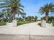 Well-manicured front yard with lush landscaping, brick columns, and a paved driveway leading to the home at 1601 S Riverside Dr, Edgewater, FL 32132