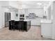 Modern kitchen with stainless steel appliances, white cabinetry, and an island with bar stool seating at 1601 S Riverside Dr, Edgewater, FL 32132
