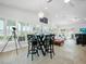 Living room with large windows, a table and chairs, and neutral decor, creating a bright atmosphere at 1601 S Riverside Dr, Edgewater, FL 32132