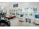 Bright living room featuring natural light, plantation shutters, and multiple seating areas at 1601 S Riverside Dr, Edgewater, FL 32132
