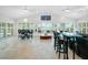 Expansive living room with tile floors, bar seating, and great views from plantation shuttered windows at 1601 S Riverside Dr, Edgewater, FL 32132