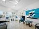 Cozy living room featuring ample natural light, plantation shutters, and a modern entertainment setup at 1601 S Riverside Dr, Edgewater, FL 32132