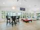 Bright and airy living area with high ceilings, a long table and chairs, and ample natural light at 1601 S Riverside Dr, Edgewater, FL 32132