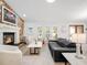 Beautiful living room boasts modern furniture, fireplace, and plenty of natural light at 1601 S Riverside Dr, Edgewater, FL 32132