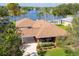 Aerial view of a single-story brick home with a well-manicured lawn and a nearby lake at 1688 Town Park Dr, Port Orange, FL 32129