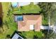 Aerial view of the property and backyard pool surrounded by a lush green lawn at 1688 Town Park Dr, Port Orange, FL 32129