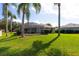 View of the screened pool and generous backyard with mature landscaping at 1688 Town Park Dr, Port Orange, FL 32129