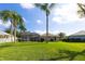 View of the screened pool and generous backyard with mature landscaping at 1688 Town Park Dr, Port Orange, FL 32129