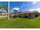 View of the generous backyard with mature landscaping and enclosed pool at 1688 Town Park Dr, Port Orange, FL 32129