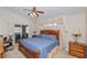 Relaxing bedroom with access to an outdoor patio, featuring stylish furnishings and a ceiling fan at 1688 Town Park Dr, Port Orange, FL 32129