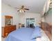 Serene bedroom with sliding glass doors to the outside, complete with elegant furnishings and a ceiling fan at 1688 Town Park Dr, Port Orange, FL 32129