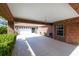 Wide carport area with brick columns leading to a garage and entryway at 1688 Town Park Dr, Port Orange, FL 32129