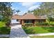 A charming single-story brick home with a well-manicured lawn and beautiful landscaping at 1688 Town Park Dr, Port Orange, FL 32129