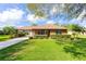 Lovely single-story brick home featuring a carport, well-maintained lawn, and lush landscaping at 1688 Town Park Dr, Port Orange, FL 32129