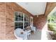 Charming front porch with a brick exterior and white wicker furniture at 1688 Town Park Dr, Port Orange, FL 32129