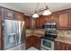Kitchen boasts stainless steel appliances, granite countertops, and dark wood cabinetry at 1688 Town Park Dr, Port Orange, FL 32129