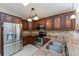 Well-lit kitchen with stainless steel appliances, dark cabinets, and granite countertops at 1688 Town Park Dr, Port Orange, FL 32129