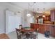 Open eat-in kitchen with adjacent dining area and built-in breakfast bar and rich wood cabinetry at 1688 Town Park Dr, Port Orange, FL 32129