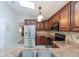 Bright kitchen featuring stainless steel appliances, dark cabinets, and a skylight at 1688 Town Park Dr, Port Orange, FL 32129