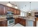 Spacious kitchen featuring stainless steel appliances, dark cabinets, and granite countertops at 1688 Town Park Dr, Port Orange, FL 32129