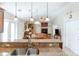 Bright open kitchen view with granite countertops, stainless steel sink, and seamless flow into the living room with fireplace at 1688 Town Park Dr, Port Orange, FL 32129