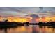 Breathtaking sunset view over a serene lake with a fountain, reflecting vibrant colors on the water at 1688 Town Park Dr, Port Orange, FL 32129