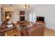 Cozy living room showcasing a brick fireplace, vaulted ceiling, and hardwood flooring at 1688 Town Park Dr, Port Orange, FL 32129