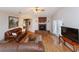 Spacious living room with a brick fireplace, hardwood floors and large sofas at 1688 Town Park Dr, Port Orange, FL 32129