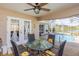 Covered patio featuring a dining table and chairs with a relaxing view of the pool at 1688 Town Park Dr, Port Orange, FL 32129
