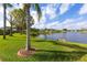 Scenic view of a community pond surrounded by lush green lawns and mature trees at 1688 Town Park Dr, Port Orange, FL 32129