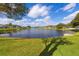 Wide view of the community pond surrounded by residential homes and manicured lawns at 1688 Town Park Dr, Port Orange, FL 32129