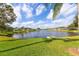 Lush lawn view of a tranquil pond surrounded by homes in a well-maintained community at 1688 Town Park Dr, Port Orange, FL 32129