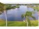 Overhead shot of a serene community pond with a fountain surrounded by lush greenery at 1688 Town Park Dr, Port Orange, FL 32129