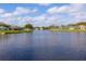 Expansive view of a community pond, showcasing waterfront properties and clear skies at 1688 Town Park Dr, Port Orange, FL 32129
