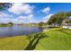 Scenic view of a serene community pond surrounded by lush green lawns and trees on a clear day at 1688 Town Park Dr, Port Orange, FL 32129