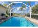 Tranquil pool with waterfall feature and views of the lake at 1688 Town Park Dr, Port Orange, FL 32129