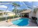 Enclosed backyard pool features a rock waterfall, plenty of deck space, and access to the home at 1688 Town Park Dr, Port Orange, FL 32129