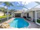 Enclosed backyard pool features a rock waterfall, plenty of deck space, and access to the home at 1688 Town Park Dr, Port Orange, FL 32129