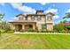 Charming two-story home featuring manicured lawn and landscaping with a welcoming front porch at 1703 Frogs Leap Ct, Port Orange, FL 32128