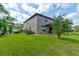 Exterior view of a well-maintained home with a lush green lawn and a car parked in the driveway at 1703 Frogs Leap Ct, Port Orange, FL 32128