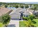 Beautiful aerial view of a single-story home, lush green lawn, and tranquil lake backdrop at 1748 Savannah Ln, Port Orange, FL 32128