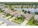 An aerial view shows waterfront homes with manicured lawns and lush landscaping at 1748 Savannah Ln, Port Orange, FL 32128