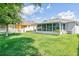 Spacious backyard with a screened-in lanai and well-maintained lawn, perfect for outdoor entertaining and relaxation at 1748 Savannah Ln, Port Orange, FL 32128