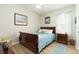 Comfortable bedroom featuring a sleigh bed, a wood nightstand, and natural light from the window at 1748 Savannah Ln, Port Orange, FL 32128