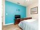 Bright bedroom with a blue accent wall, a sleigh bed, and a wood dresser with television at 1748 Savannah Ln, Port Orange, FL 32128