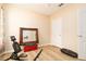 Bright bedroom with light-toned walls, hard wood floors, and a large mirror for decor at 1748 Savannah Ln, Port Orange, FL 32128