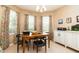 Dining area filled with natural light, featuring tile floors, table, and chairs at 1748 Savannah Ln, Port Orange, FL 32128