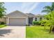 Charming single-story home featuring a well-manicured lawn and attached two-car garage at 1748 Savannah Ln, Port Orange, FL 32128