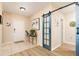 Bright entryway showcasing wood-look floors and a decorative barn door at 1748 Savannah Ln, Port Orange, FL 32128